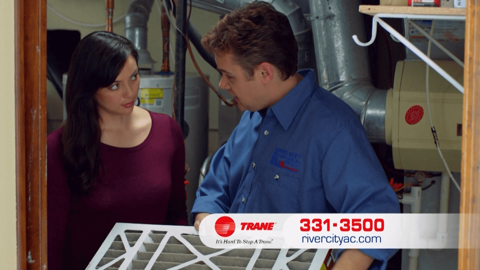 A woman discussing with a technician from River City Heating & Cooling | Emergency HVAC Services